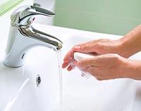 washing hands to reduce germs with warm soapy water